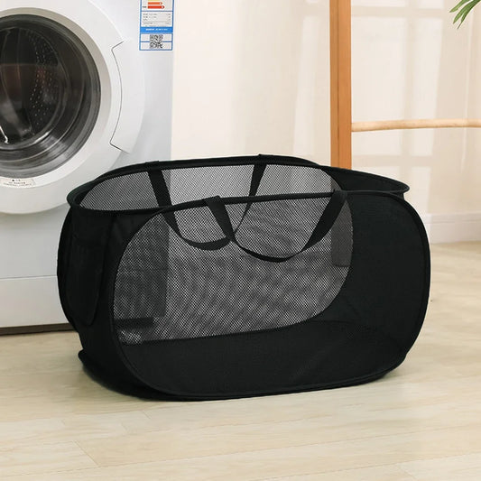 Foldable mesh laundry basket with handles shown being carried and filled with clothes in a home setting