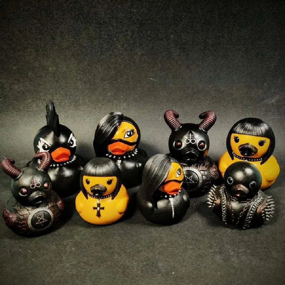 Set of black and yellow rubber duck toys with unique designs on a dark background