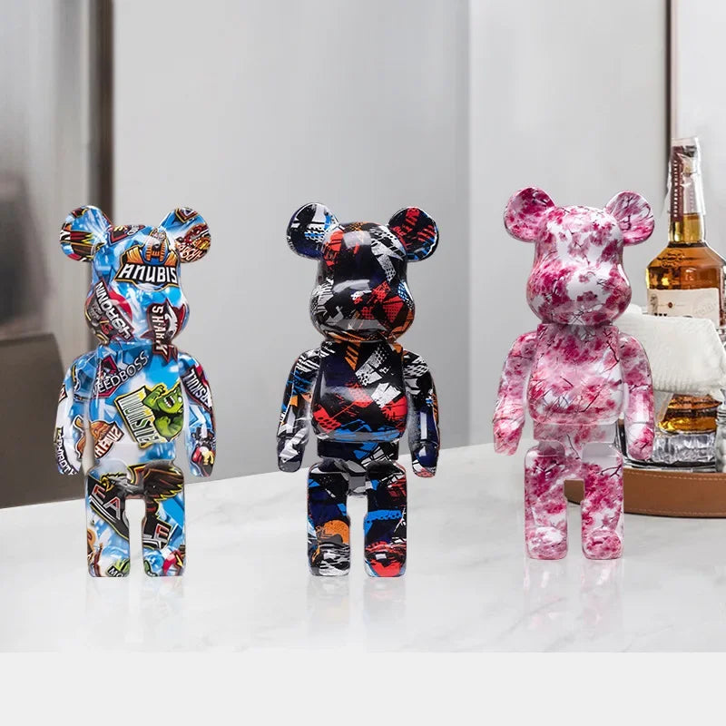 Three colorful bear figurines on a white surface with a blurred background
