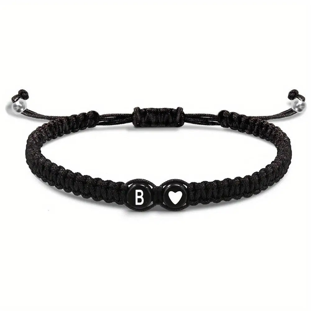 Black braided bracelet with letter 'B' and heart charm on a white background