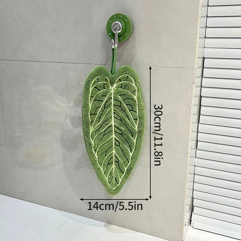 Green leaf-shaped mat with measurement details on a neutral background