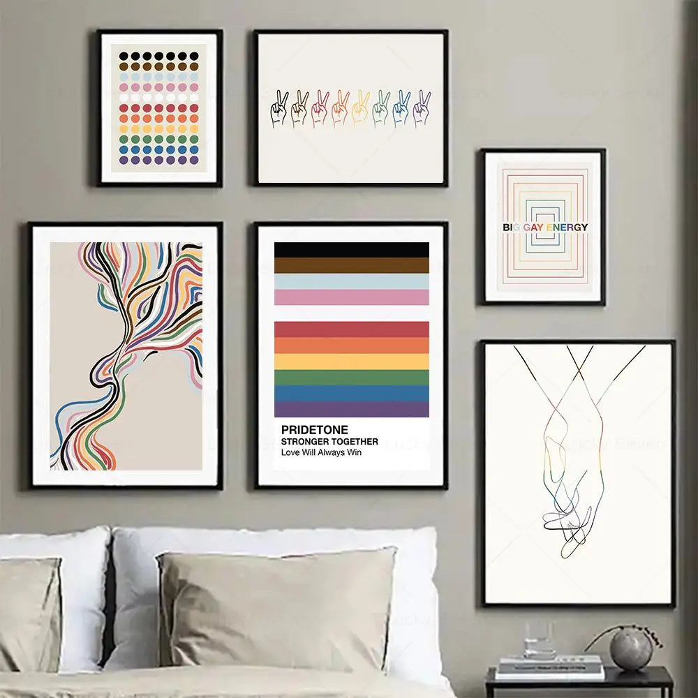 Wall with framed art pieces including a Pride-themed poster, with a couch and decor items in the foreground.