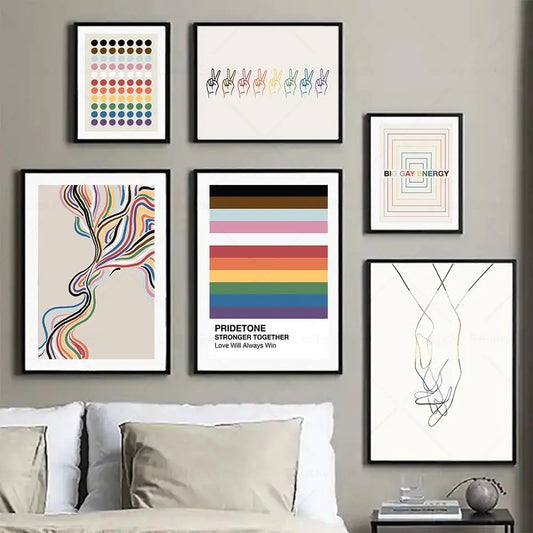 Wall with framed art pieces including a Pride-themed poster, with a couch and decor items in the foreground.