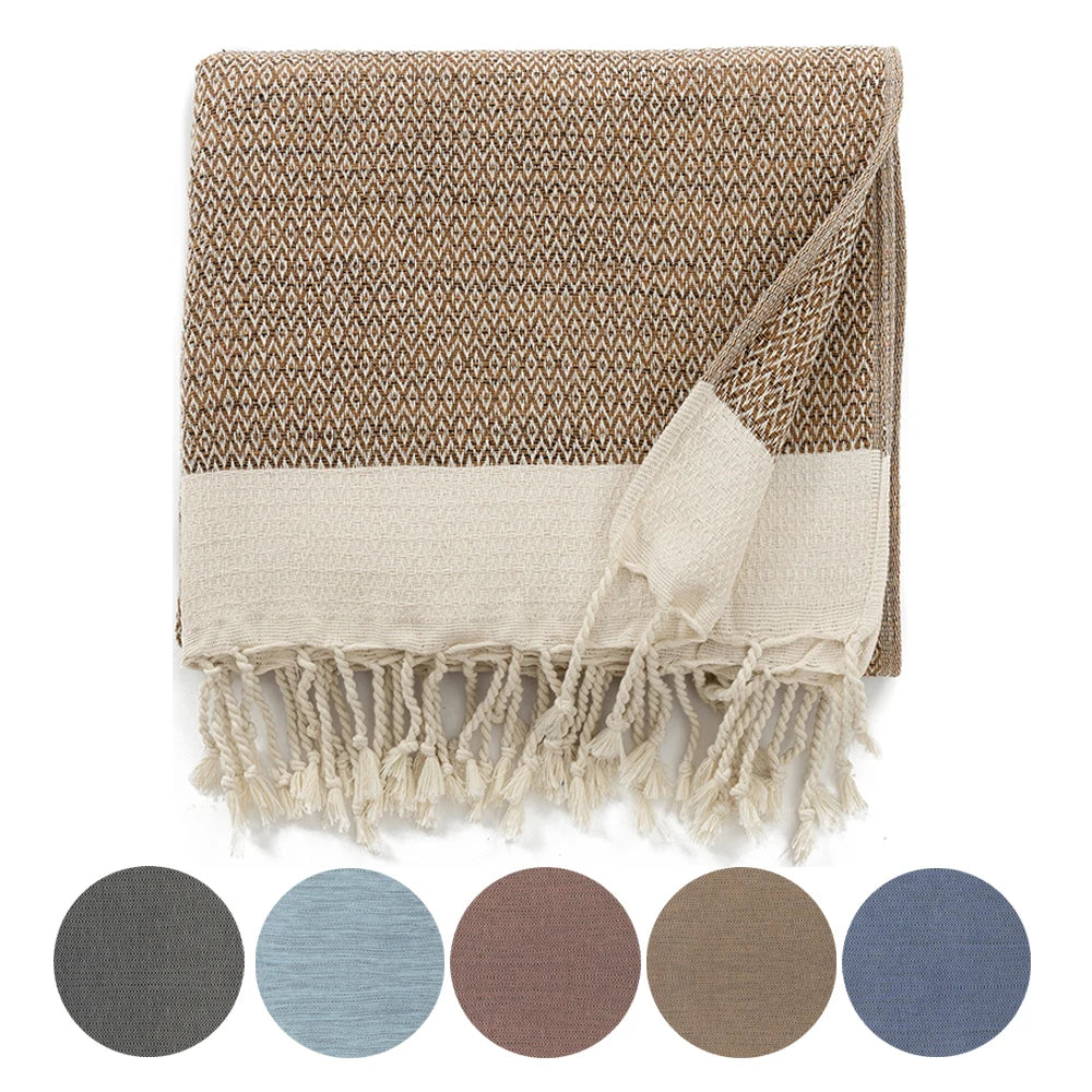 turkish woven cotton throw blanket with tassels folded on sofa neutral home decor