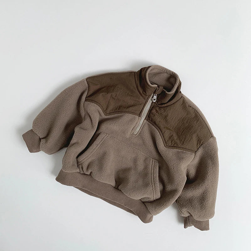 Brown fleece pullover on a light gray background
