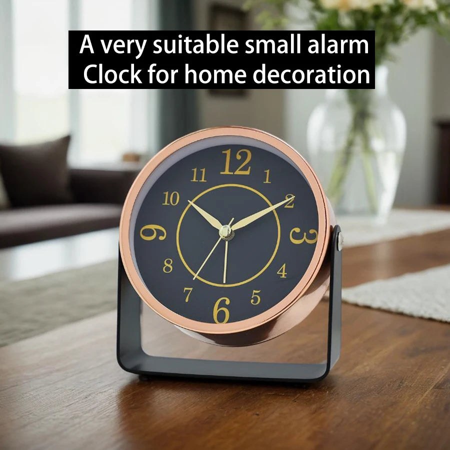 Small alarm clock on a wooden table with a blurred background