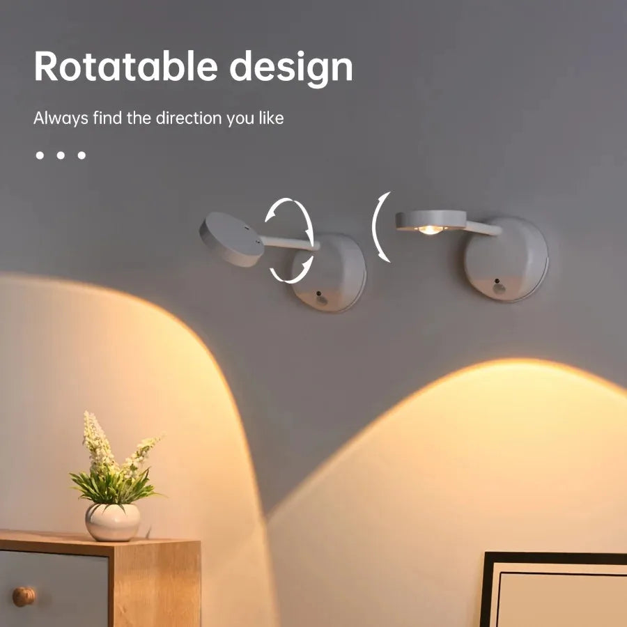 Wall-mounted light fixture with rotatable design on a gray wall.