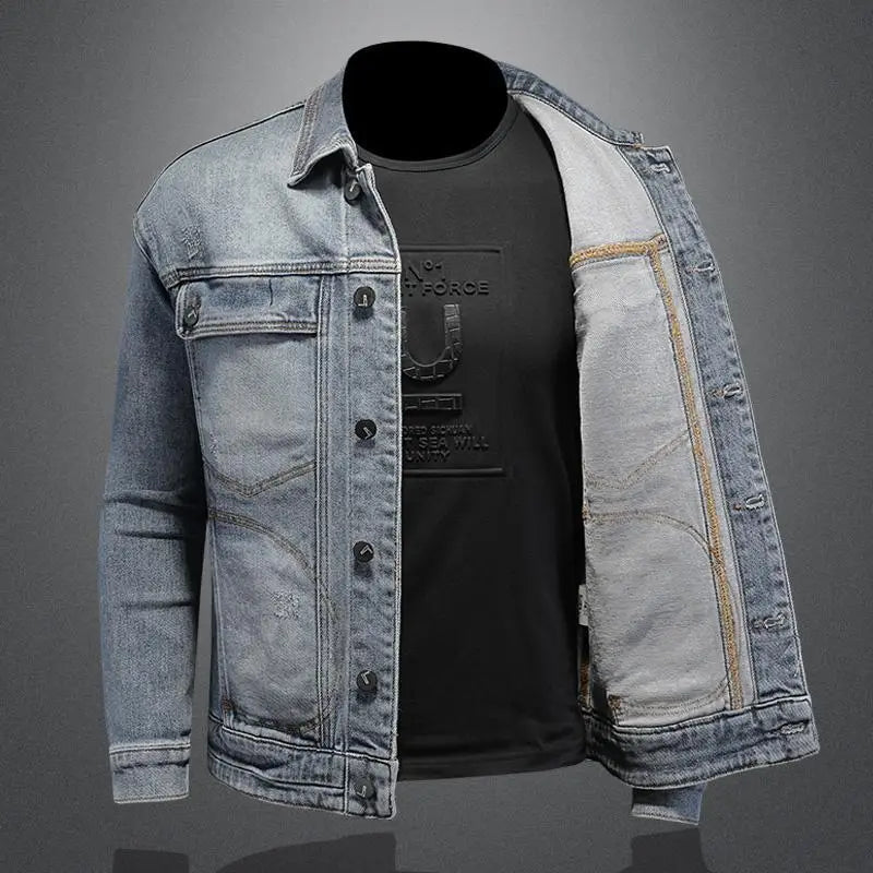 Denim jacket with a black shirt underneath on a gray background