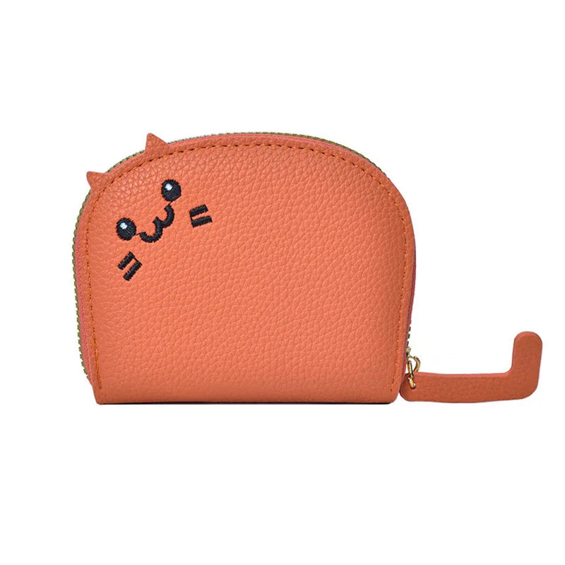 Orange coin purse with a cartoon face on a white background