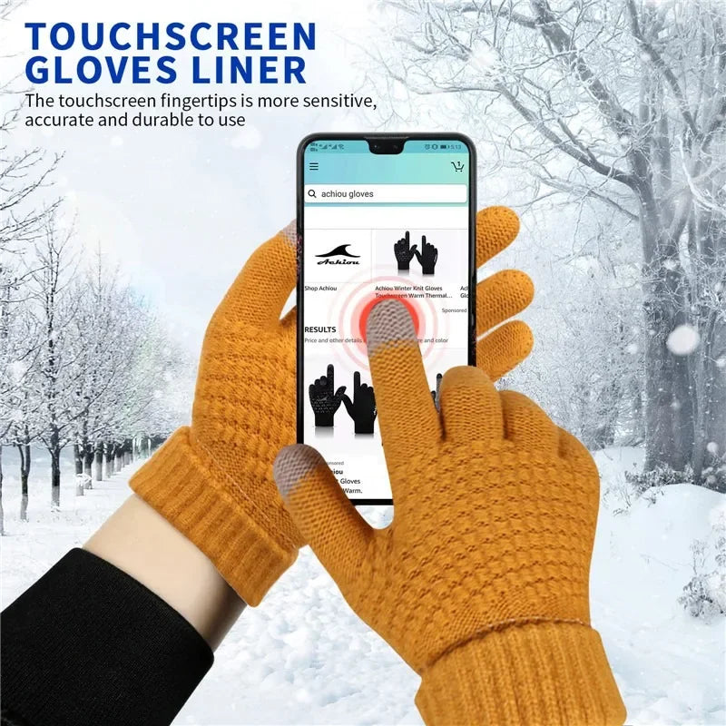 Person wearing touchscreen gloves using a smartphone in a snowy landscape