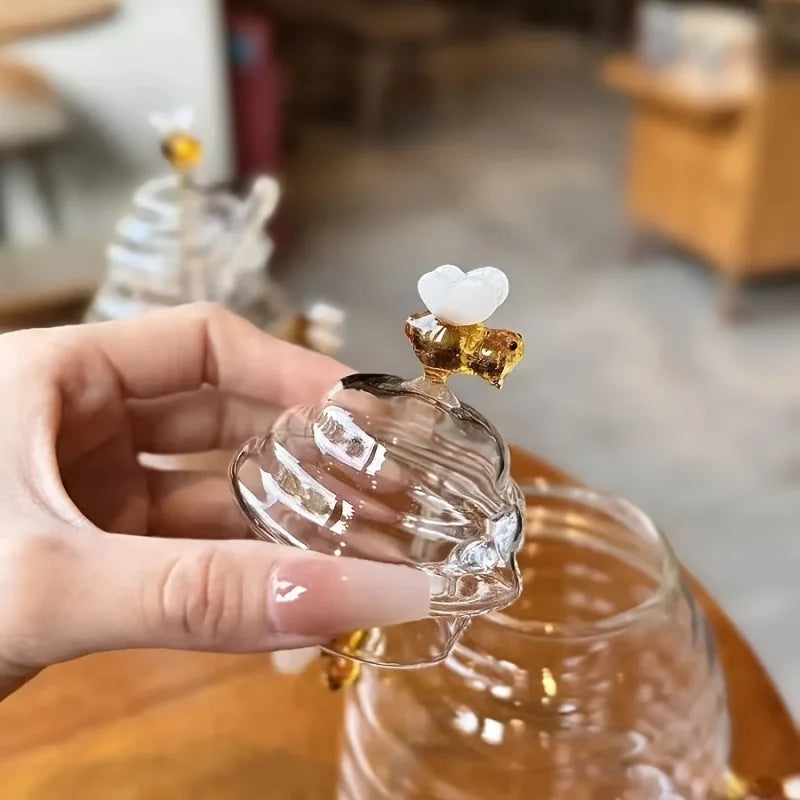 Clear glass object with decorative top held by a hand in an indoor setting