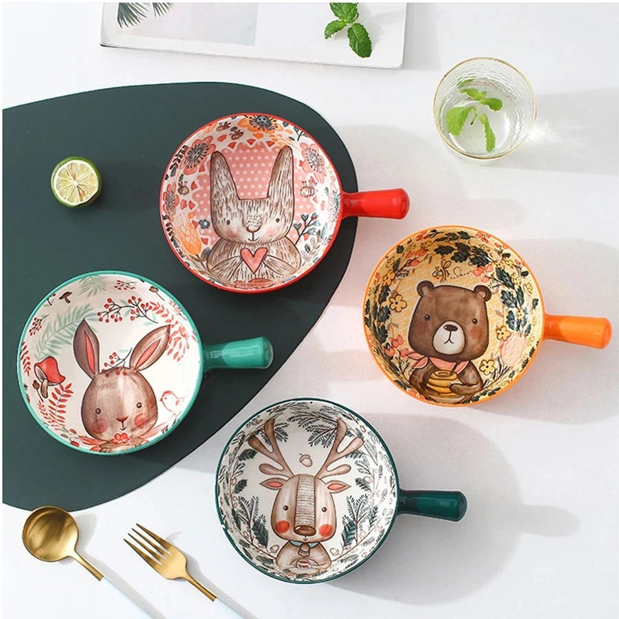 Set of colorful ceramic pots with animal designs on a white surface.