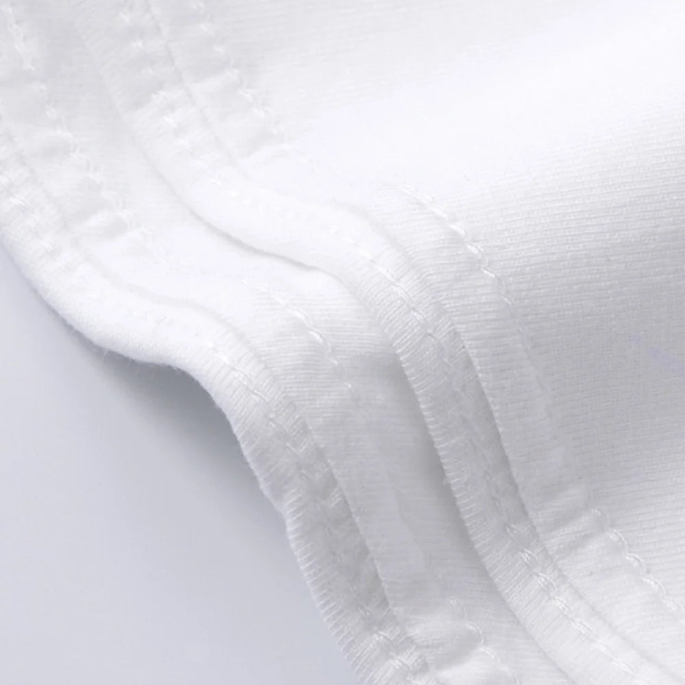 Close-up of white fabric with a textured pattern on a light gray background