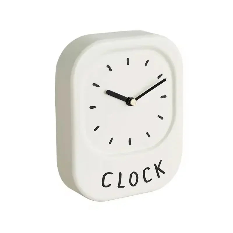 White wall clock with 'CLOCK' text on a white background