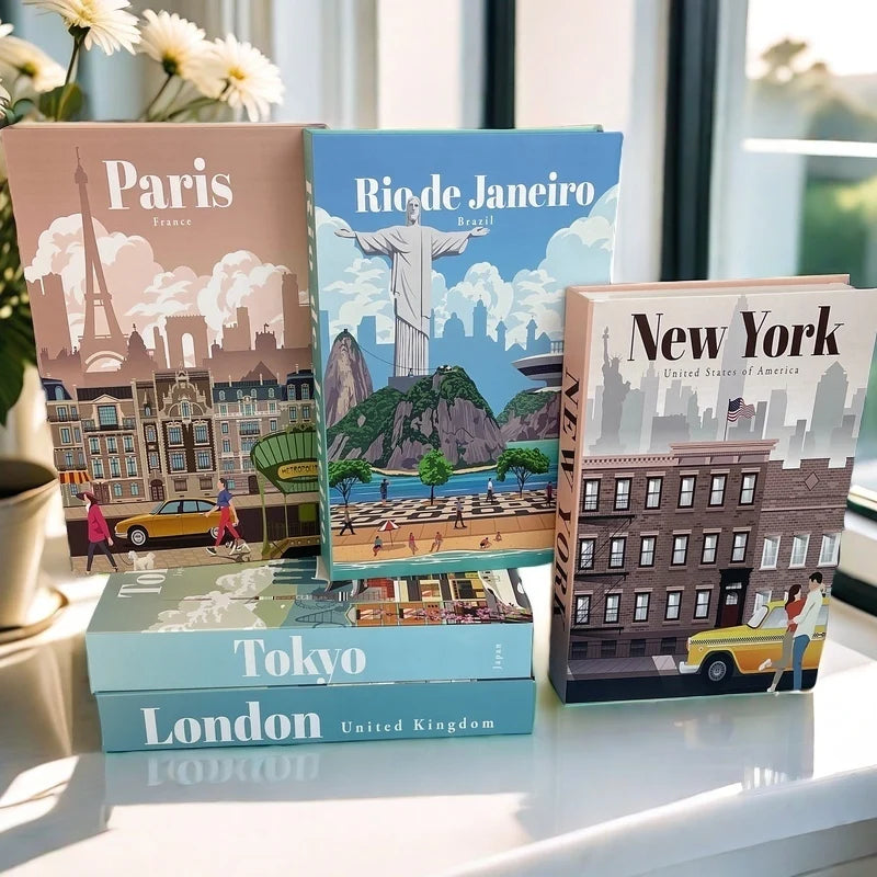 Four Decorative storage travel-themed books on a table with cityscapes and landmarks.