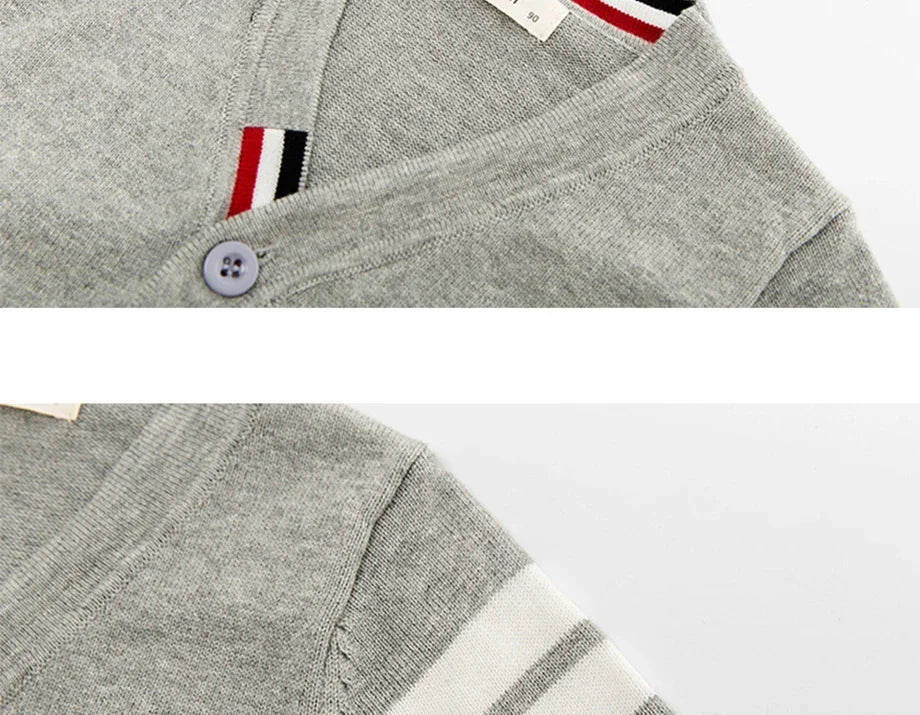 Grey sweater with a button and brand logo on a white background