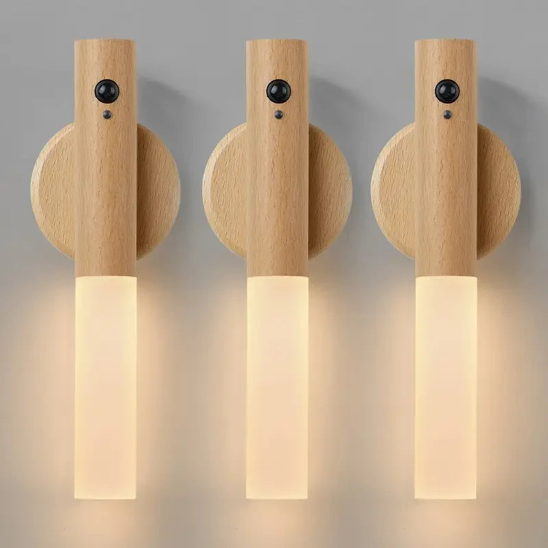 Three wooden wall sconces with light bulbs on a gray background