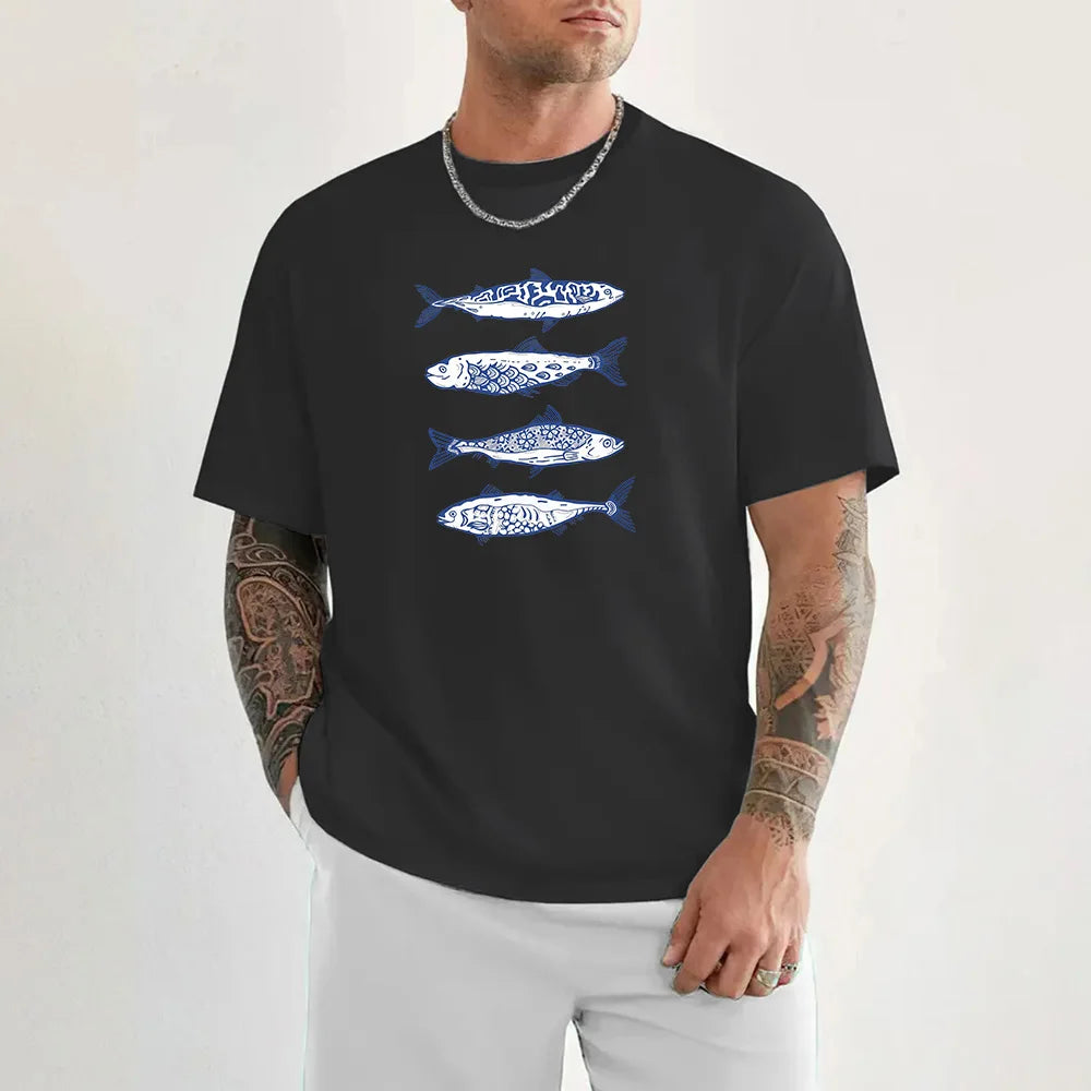 Man wearing a black t-shirt with blue fish designs on a white background
