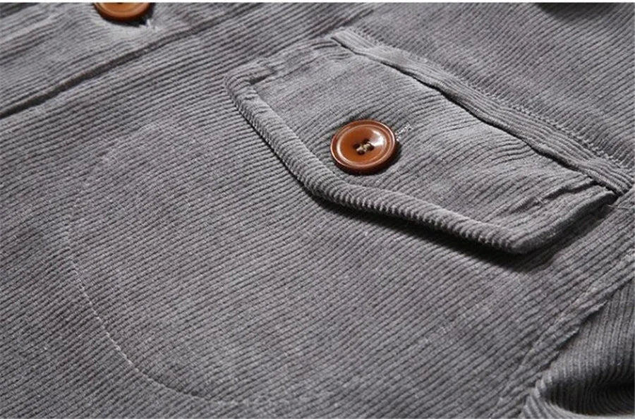 Close-up of a gray corduroy jacket with a buttoned pocket
