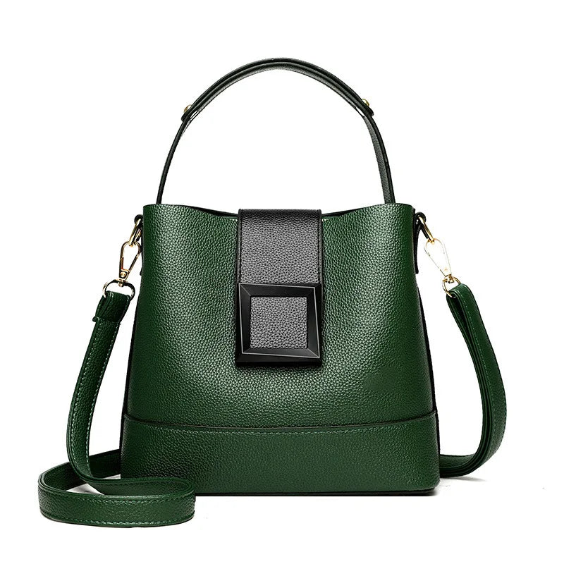 Green handbag with a black square accent on a white background