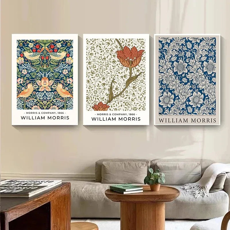 Three William Morris artworks hanging on a wall above a sofa.