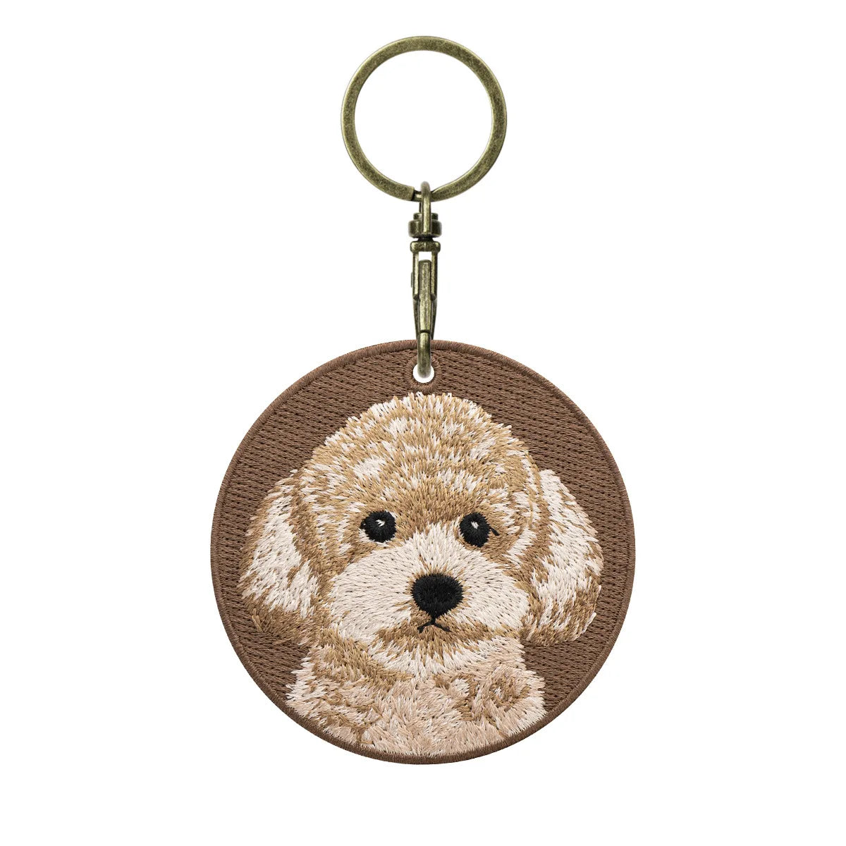 Keychain with embroidered dog design on a brown background