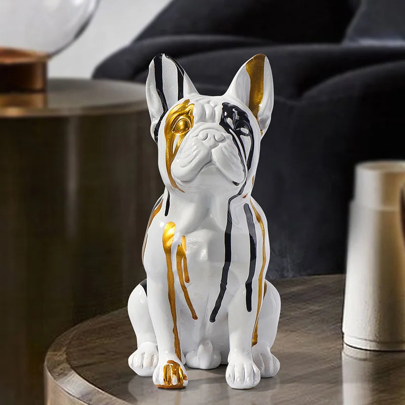 Decorative statue of a dog with gold and black accents on a wooden surface.