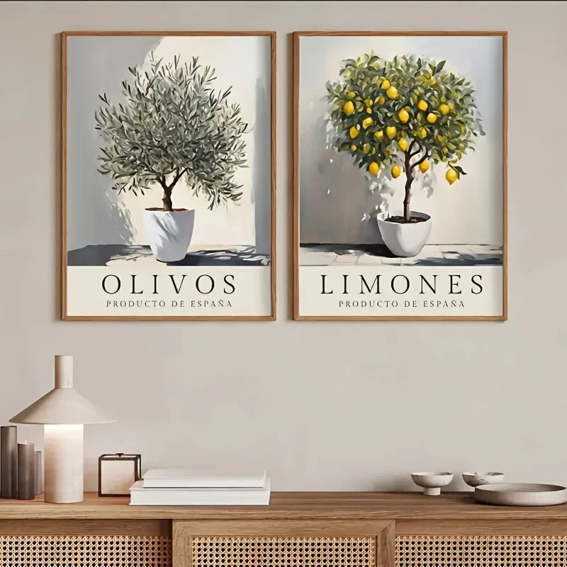 Two framed prints of olive and lemon trees on a wall above a wooden console table.