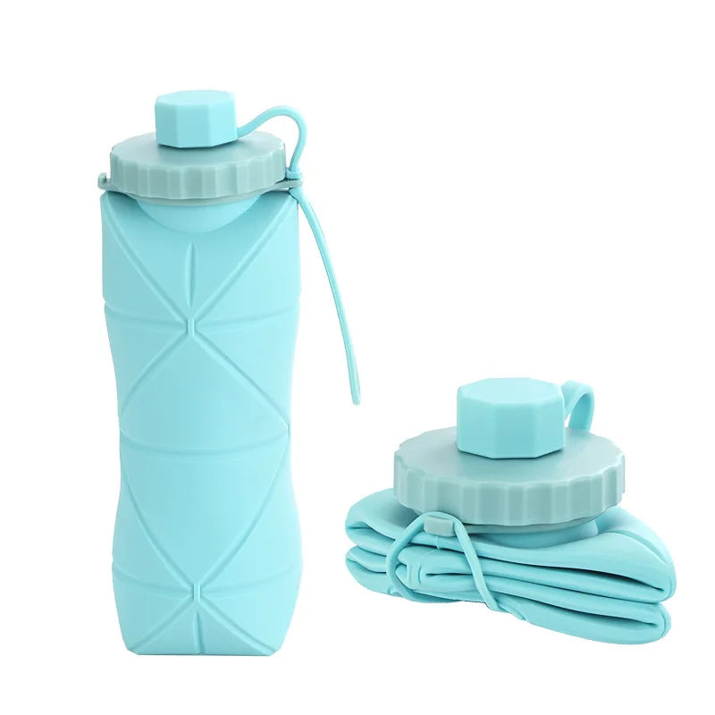Collapsible light blue water bottle with carrying strap on a white background