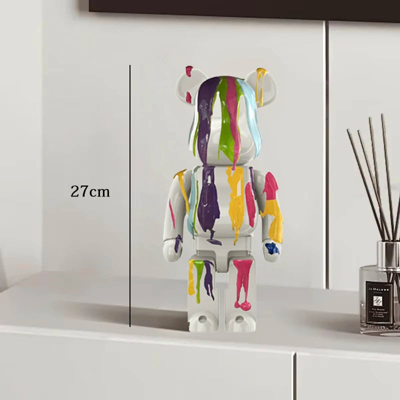 Colorful bear figurine with a measurement label on a white surface