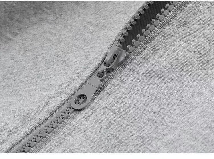 Close-up of a zipper on a gray fabric background