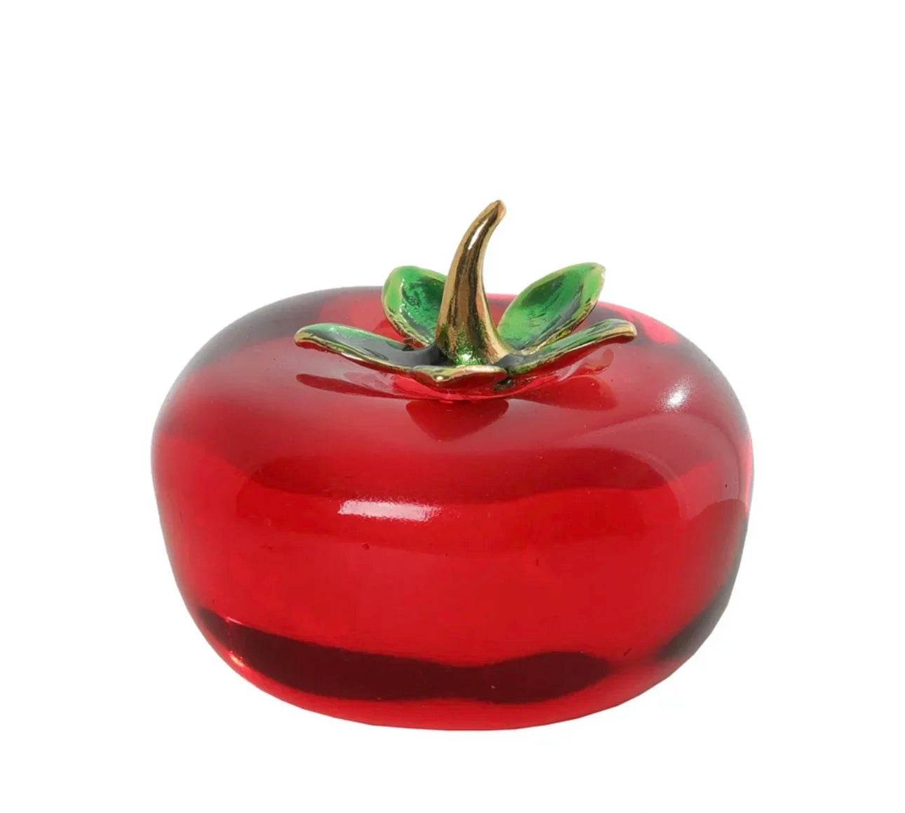 Red ceramic apple with gold stem on a white background