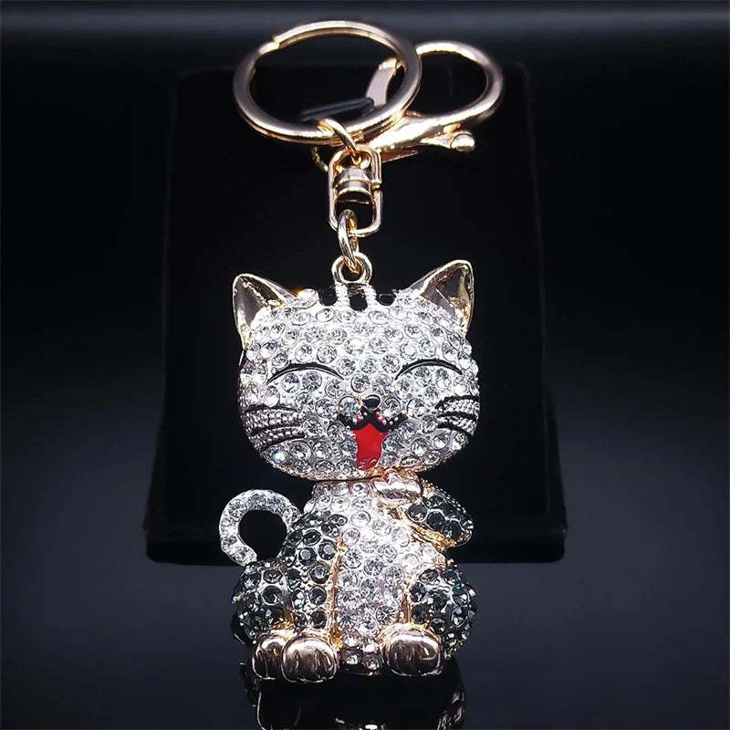 Cat-shaped keychain with rhinestones on a black background