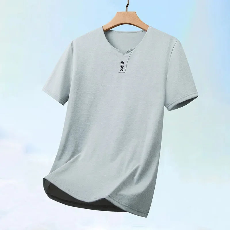 Gray t-shirt on a wooden hanger against a light blue gradient background