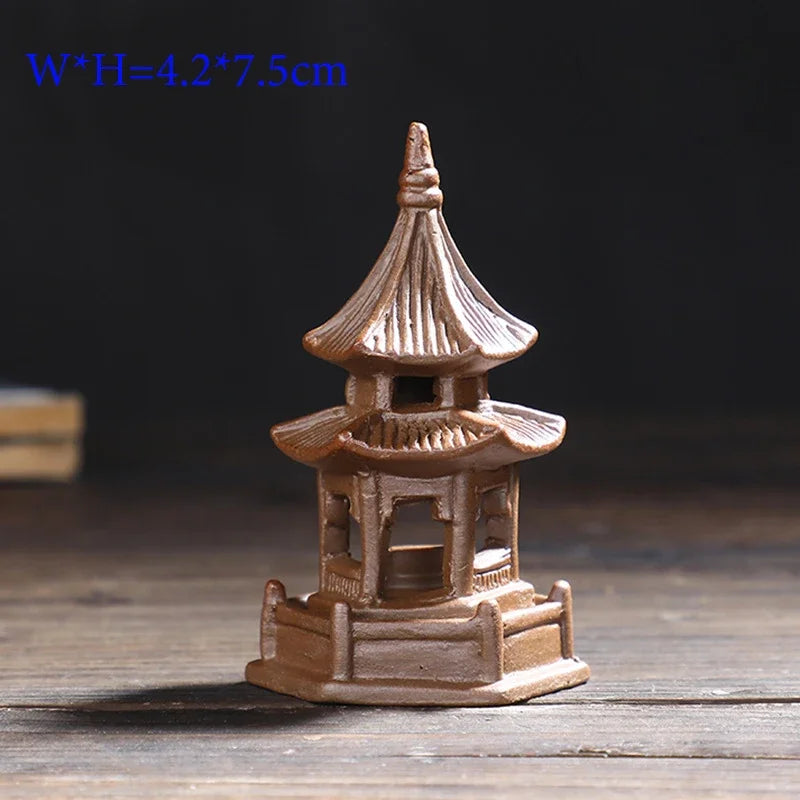 Small model of a pagoda on a wooden surface with a dark background