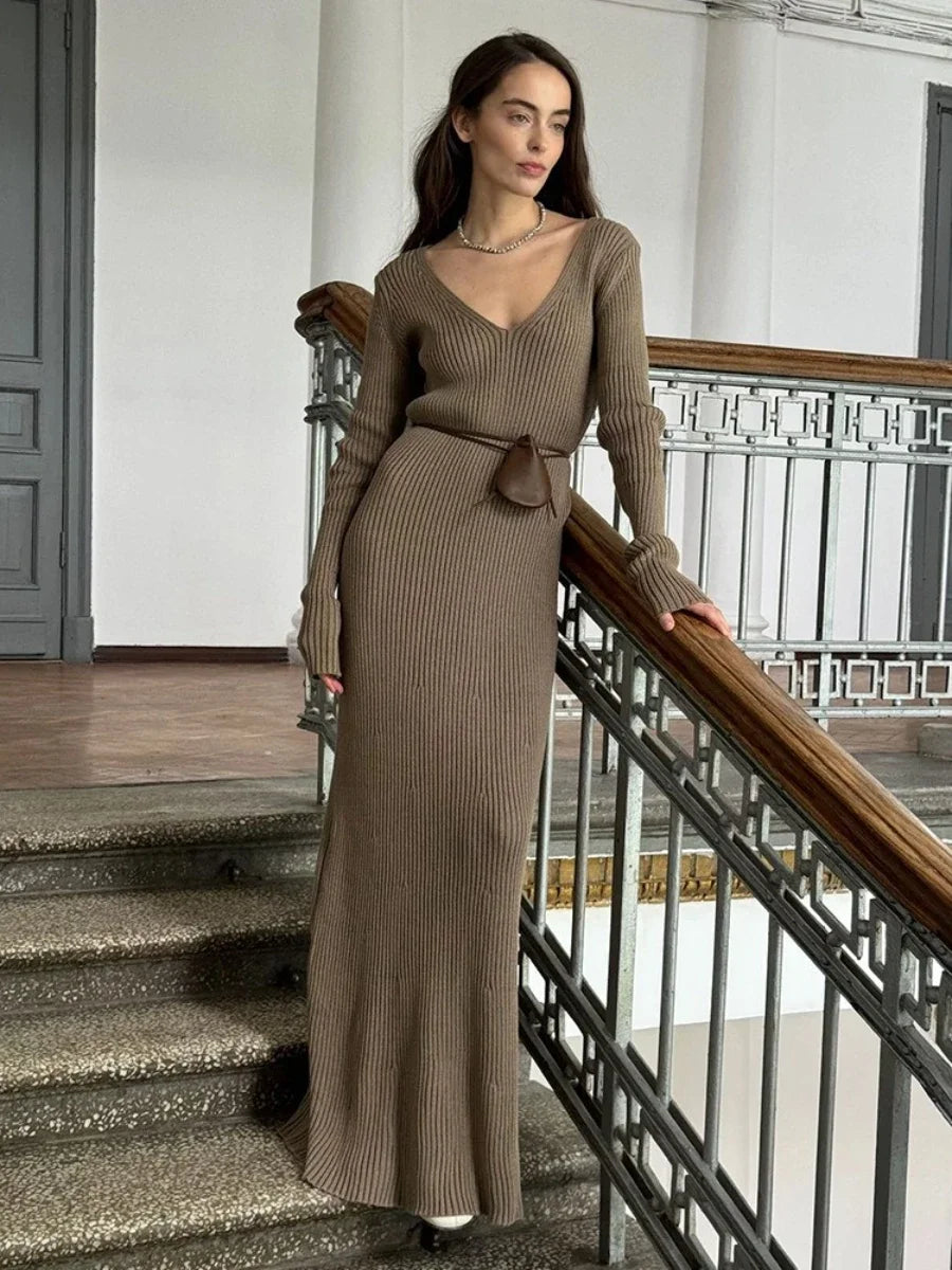 Woman wearing a cream ribbed knitted maxi dress with V-neck and long sleeves, Blubelle fashion.