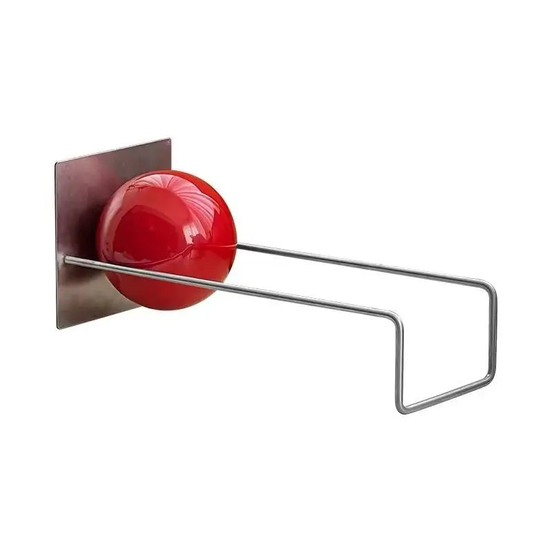 Modern metal desktop bookshelf with red decorative sphere holding books on a contemporary white desk.
