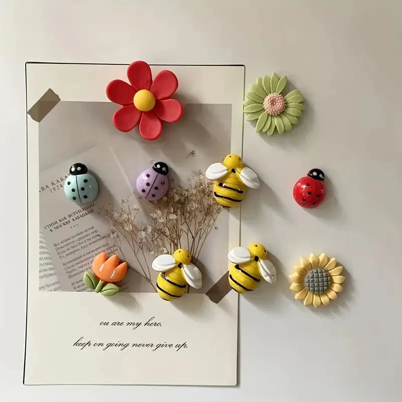 Cute bee and flower fridge magnets set with pastel floral and ladybird designs displayed on minimalist refrigerator surface