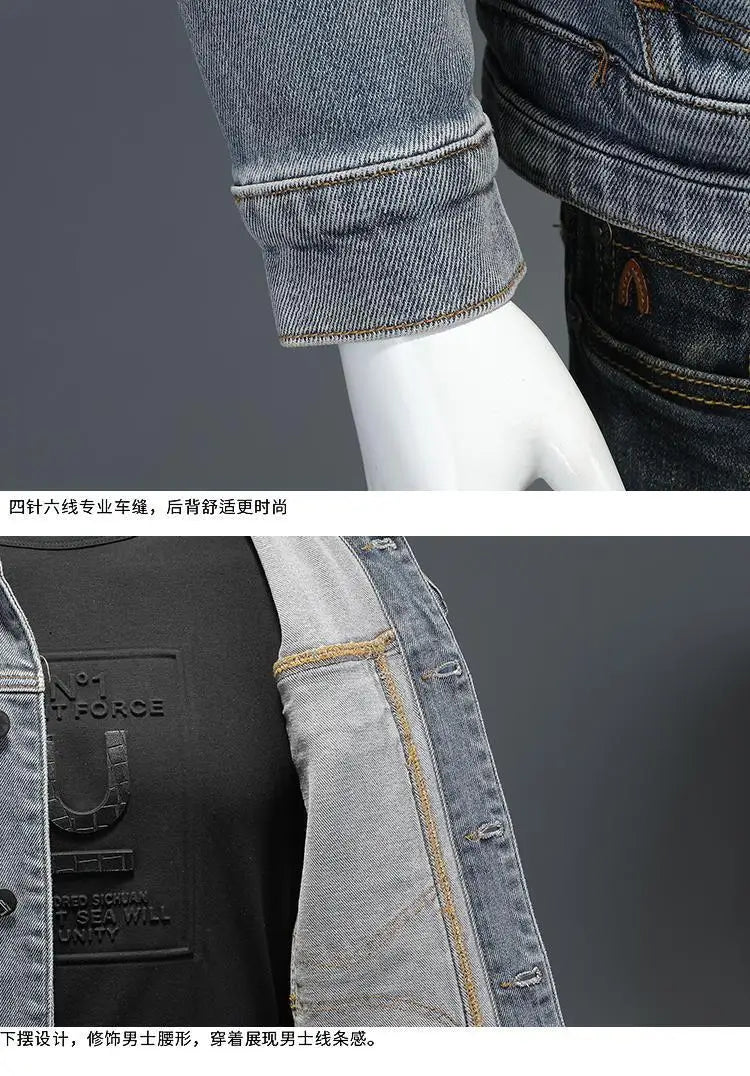 Close-up of a denim jacket with rolled-up cuffs and stitching details on a gray background.