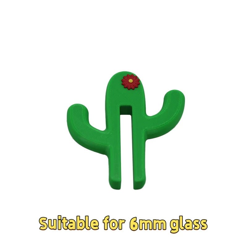 Green cactus-shaped towel holder with a red flower on a white background