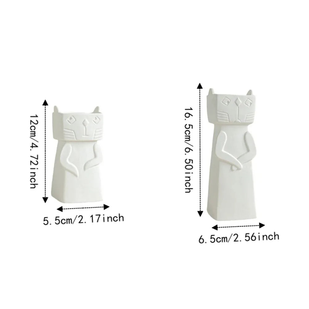 Two white cat-shaped decorative objects shown on a white background with dimension arrows and text indicating height and width in centimeters and inches.
