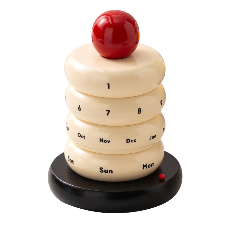 Colorful rotating cake calendar on a white surface with a blurred background, Milk Colour