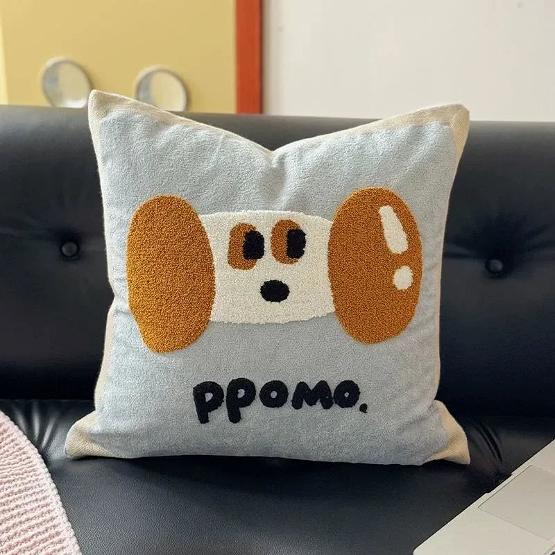Textured dog cushion covers displayed on a dark sofa.
