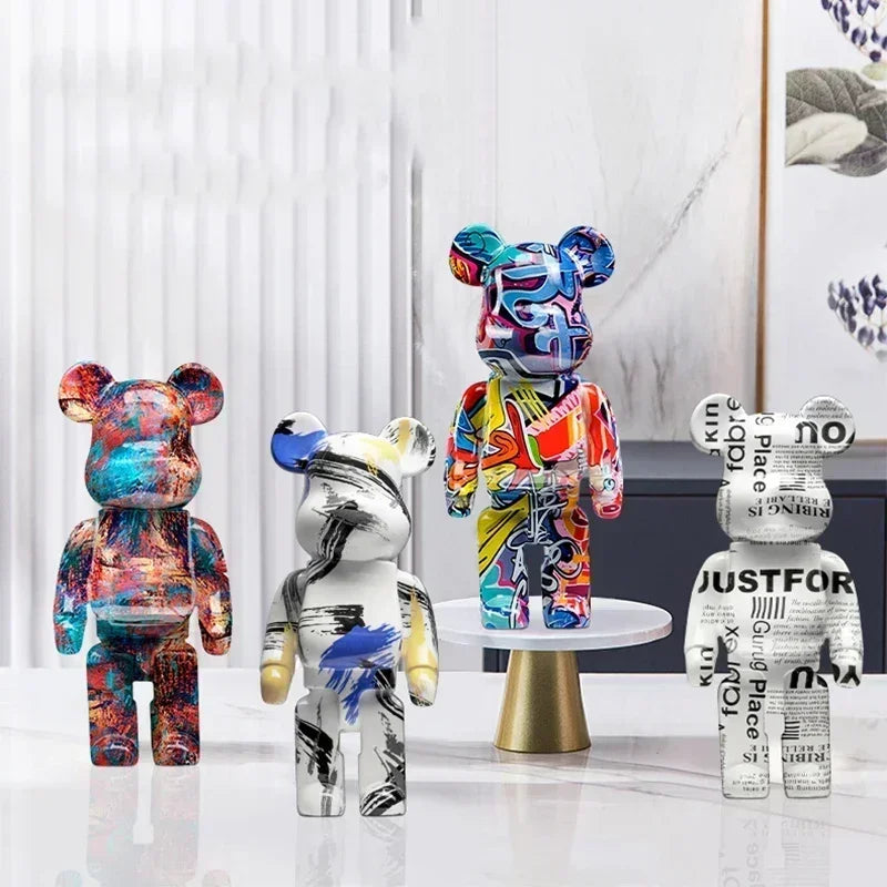 Four colorful bear-like sculptures on a white surface with a minimal background