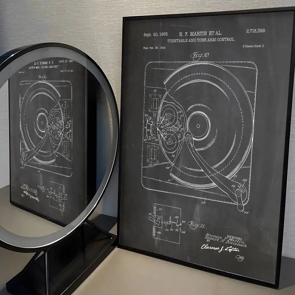 Framed blueprint of a turntable and tone arm control on a gray surface.