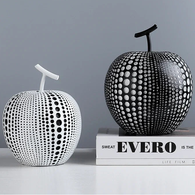 Decorative apples with black and white patterns on a gray background