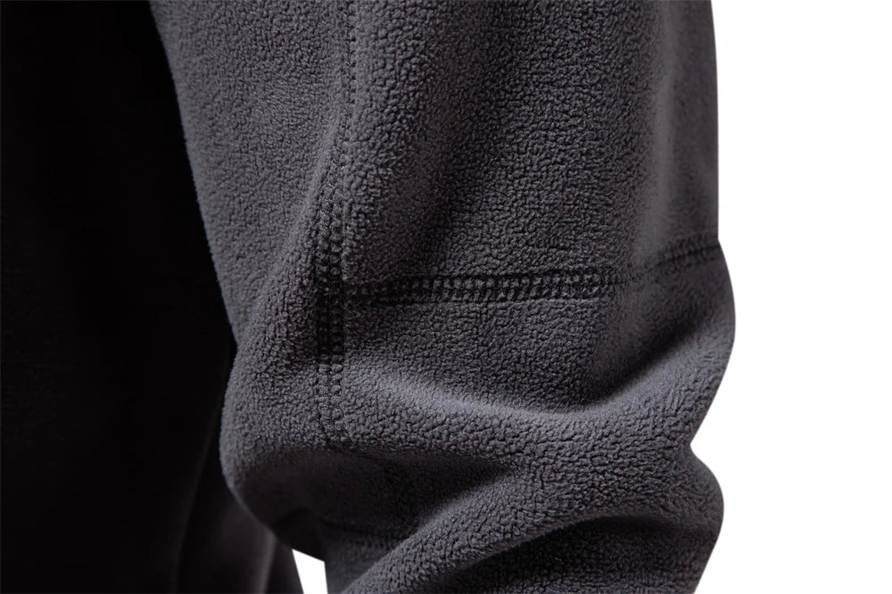 Close-up of a black fleece jacket sleeve on a white background