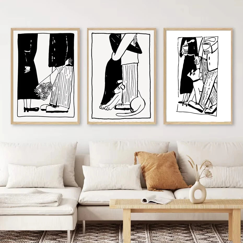 Three framed black and white minimalist art prints depicting stylized figures, displayed on a white wall above a modern beige sofa in a living room setting.