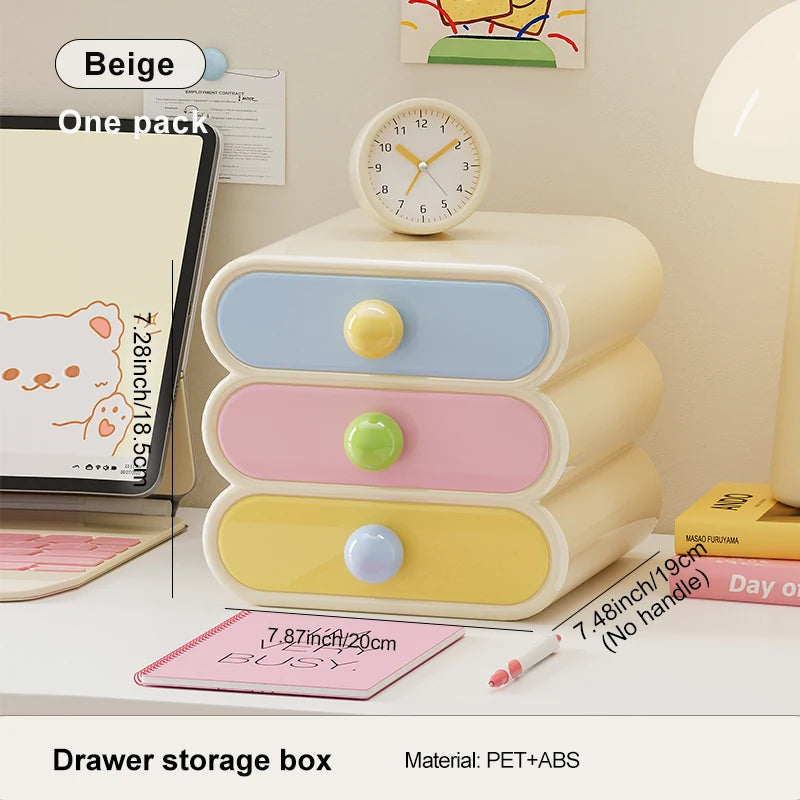 Pastel-colored drawer storage box on a desk with stationery items.