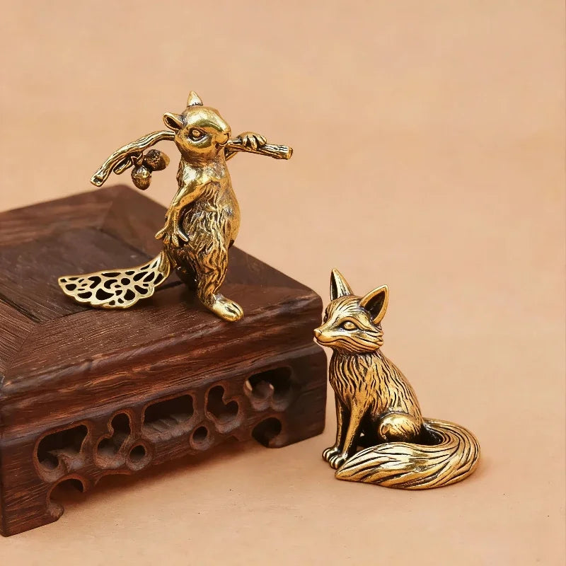 Small brass animal ornament figurine with detailed finish placed on a desk as decorative accent